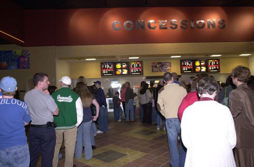 People waiting in line at concessions stand.